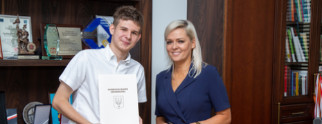 Chłopiec i kobieta pozują do zdjęcia, chłopak trzyma teczkę z herbem miasta i napisem Burmistrz Miasta Hrubieszowa